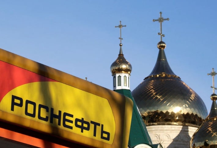 the logo of russia s top crude producer rosneft is seen on a gasoline station near a church in stavropol southern russia december 9 2014 reuters eduard korniyenko file photo