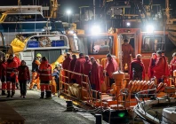 survivors of the sinking of russian cargo ship ursa major stand on the deck of a spanish maritime rescue ship upon arrival at the port of cartagena spain december 23 photo reuters