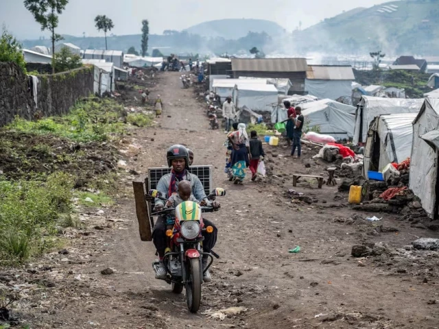 people ride past congolese people displaced by recent clashes between the m23 rebels and the armed forces of the democratic republic of the congo fardc as they prepare to leave the camp after being instructed by the m23 rebels to vacate the camps on the outskirts of goma democratic republic of the congo on february 12 2025 photo reuters people ride past congolese people displaced by recent clashes between the m23 rebels and the armed forces of the democratic republic of the congo fardc as they prepare to leave the camp after being instructed by the m23 rebels to vacate the camps on the outskirts of goma democratic republic of the congo on february 12 2025 photo reuters