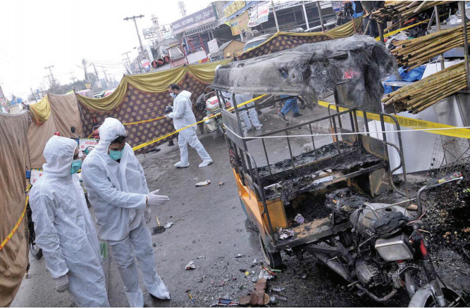 investigators in protective gear collect evidence from the blast site photo online