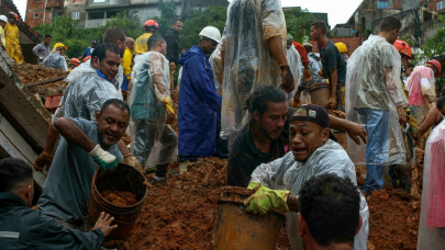 rescuers dig desperately in mud for brazil flood survivors