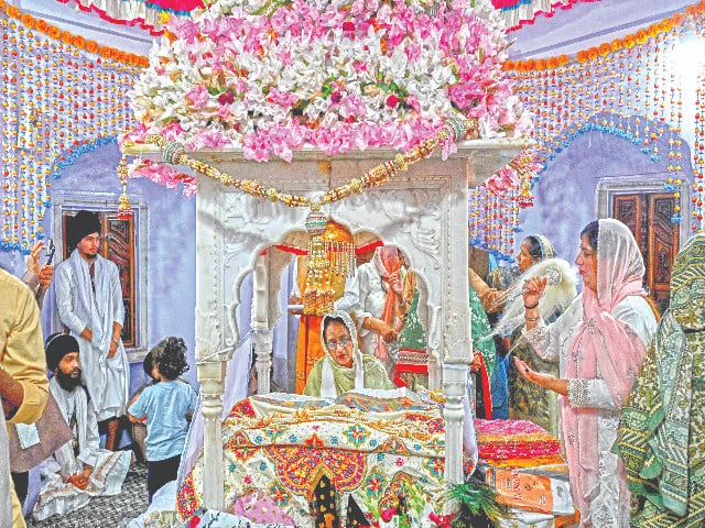 a granthi or ceremonial reader recites the guru granth sahib as devotees offer prayers in nankana sahib photo afp a granthi or ceremonial reader recites the guru granth sahib as devotees offer prayers in nankana sahib photo afp