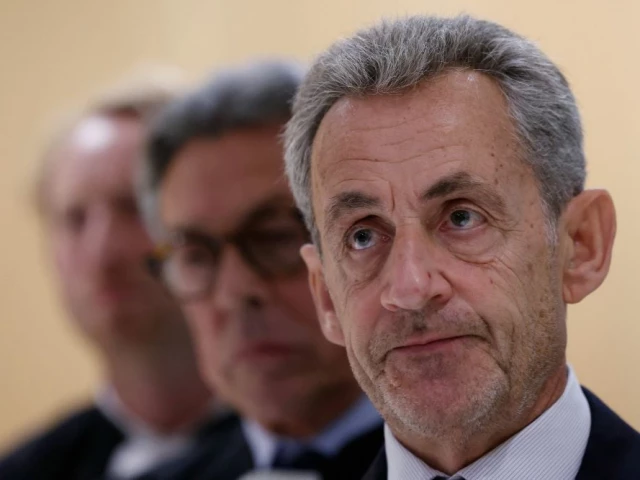 former french president nicolas sarkozy r speaks to the press next to his lawyer french jean michel darrois 2l after the verdict in his trial for illegal campaign financing from libya for his successful 2007 presidential bid at the tribunal de paris courthouse in paris on september 25 2025 photo afp