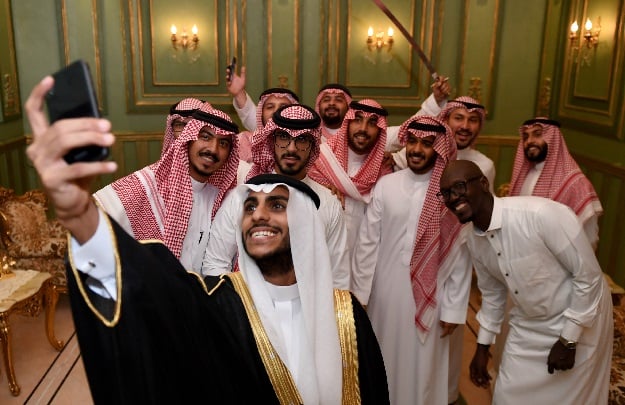 Saudi groom Basil Albani poses for a selfie with his friends during his wedding at his home in the Red Sea resort of Jeddah. PHOTO: AFP