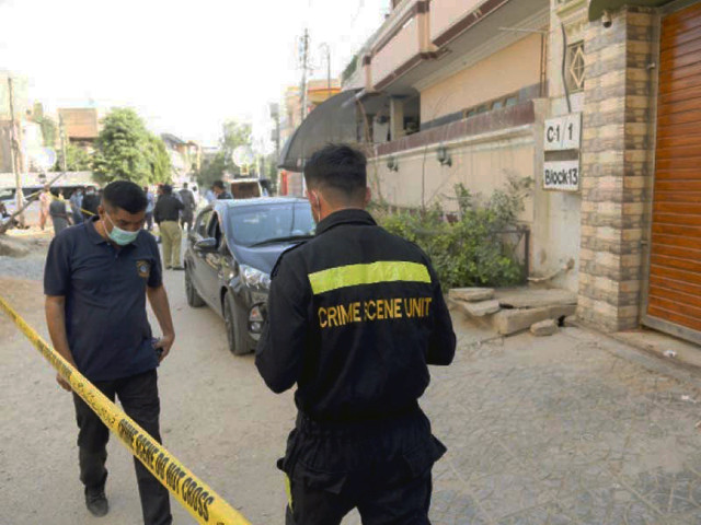 police officials collect evidence from the crime scene where sbc secretary irfan mahar was murdered photo express