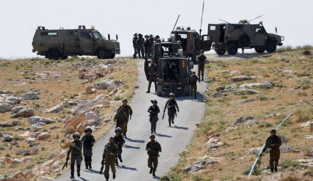 israeli troops take position during clashes between palestinians and israeli troops after israeli machinery demolish a school near bethlehem in the israeli occupied west bank may 7 2023 photo reuters israeli troops take position during clashes between palestinians and israeli troops after israeli machinery demolish a school near bethlehem in the israeli occupied west bank may 7 2023 photo reuters