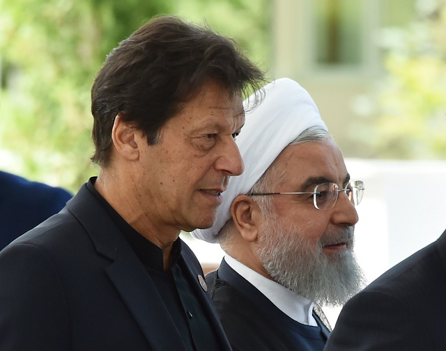 Prime Minister Imran Khan and Iran's President Hassan Rouhani walk as they attend a meeting of the Shanghai Cooperation Organisation (SCO) Council of Heads of State in Bishkek on June 14, 2019. PHOTO: AFP