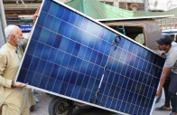 men load solar panels on a rickshaw at a market in karachi source reuters
