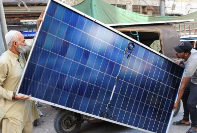 men load solar panels on a rickshaw at a market in karachi source reuters