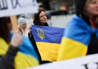 a woman holds a ukrainian flag at a protest near the united nations office on the day of u s  mediated peace talks between russia and ukraine in geneva switzerland february 17 2026 photo reuters