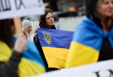 a woman holds a ukrainian flag at a protest near the united nations office on the day of u s  mediated peace talks between russia and ukraine in geneva switzerland february 17 2026 photo reuters