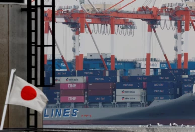 a japanese national flag flutters in front of cargo containers at an industrial port in tokyo japan february 16 2026 photo reuters