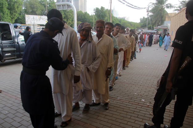 From the external entrance till the courtyard of the shrine, people must go through six checkpoints where police searchers thoroughly check them. PHOTO: ATHAR KHAN