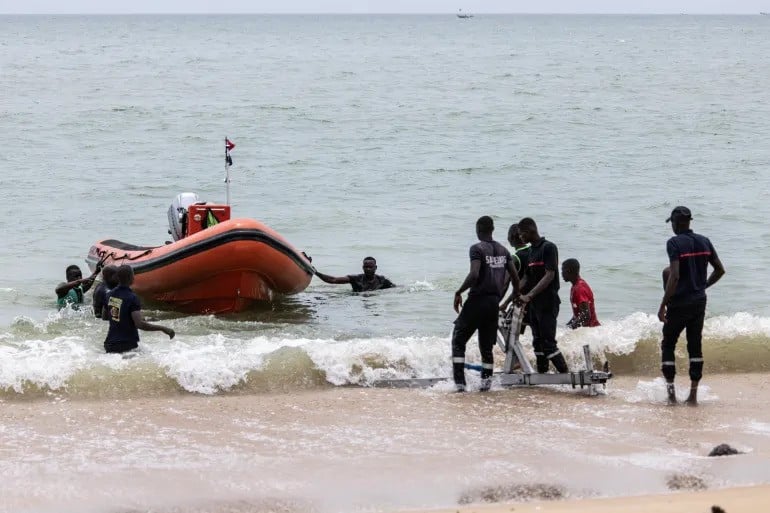 members of a search and rescue team make their way to shore during a search to find survivors and retrieve the dead after a pirogue carrying over a hundred migrants sank off mbour senegal photo afp