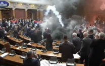 serbian parliament erupts in chaos as opposition throws smoke bombs