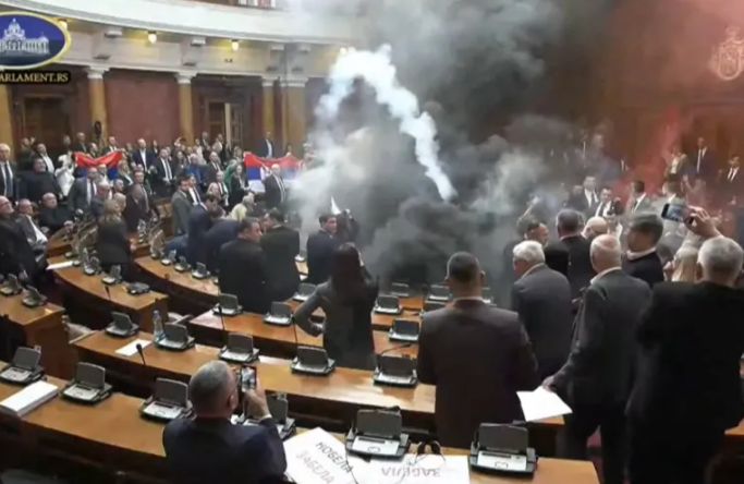 this screengrab from handout video released by the serbian government shows opposition lawmakers lighting flares and discharging suspected smoke bombs inside parliament photo afp