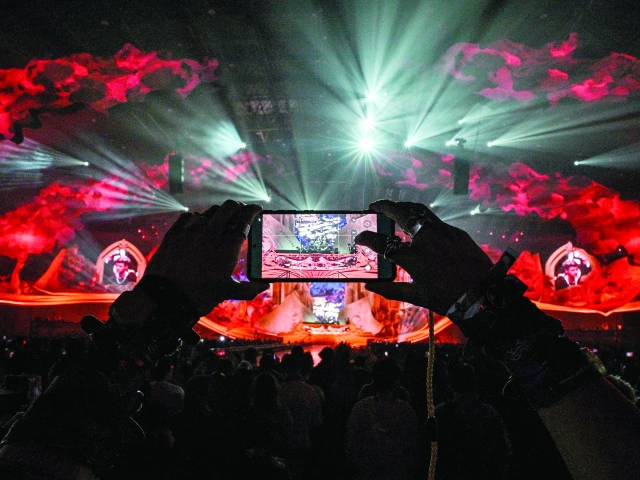 a reveler records a video during the first indoor showcase of electronic music festival the magic of tomorrowland at the hero dome in shanghai photo afp a reveler records a video during the first indoor showcase of electronic music festival the magic of tomorrowland at the hero dome in shanghai photo afp