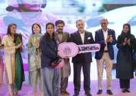 sindh senior minister sharjeel memon distributes a scooter to a woman during a ceremony on international women s day on sunday photo express