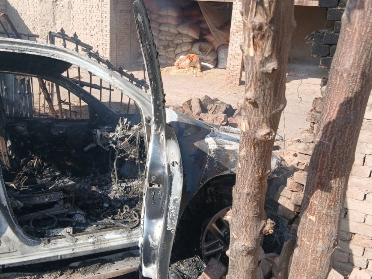 The burnt-out wreckage of Assistant Commissioner Shah Wali’s vehicle on Miranshah Road on Tuesday. PHOTO: EXPRESS