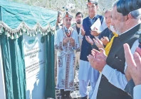 prime minister shehbaz sharif wearing traditional attire prays after unveiling the plaque for a branch of the danish school in chitral photo inp