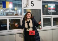 a bulgarian woman celebrates at a checkpoint at the giurgiu ruse border between romania and bulgaria on january 1 2025 photo afp