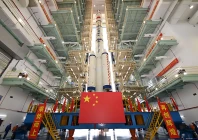 this photo taken on april 16 2025 shows the combination of the shenzhou 20 crewed spaceship and a long march 2f carrier rocket preparing to be transferred to the launching area photo xinhua