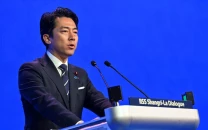 japan rejects new militarism accuses china of rapidly arming