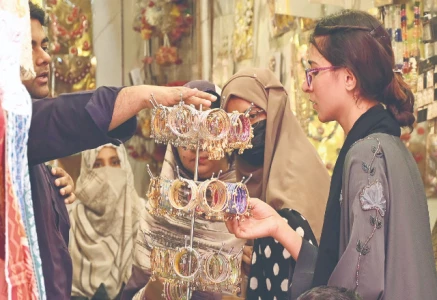 women shop for artificial jewellery in bazaar at lahore photo file