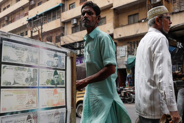 people walk past a sidewalk money exchange showcase in karachi pakistan september 12 2023 photo reuters people walk past a sidewalk money exchange showcase in karachi pakistan september 12 2023 photo reuters