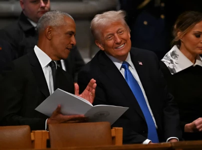 trump and obama s rare meeting at carter s funeral analysed by lip readers
