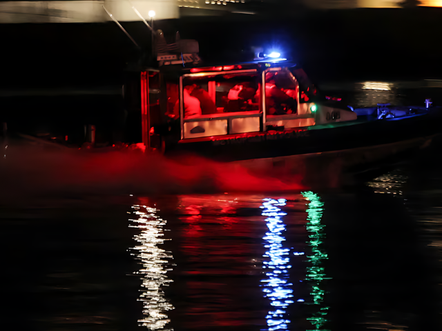 Photo: Photo: A search and rescue boat operates in the Potomac River after American Eagle flight 5342 collided with a helicopter near Ronald Reagan Washington National Airport.