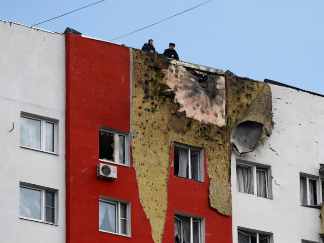 Photo: Police officers stand on the roof o residential building damaged in a recent Ukrainian drone attack, in the course of Russia-Ukraine conflict, in Moscow, Russia/Reuters