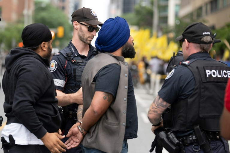 police arrest a sikh protestor during a demonstration in front of the indian consulate in toronto on july 8 2023 photo afp