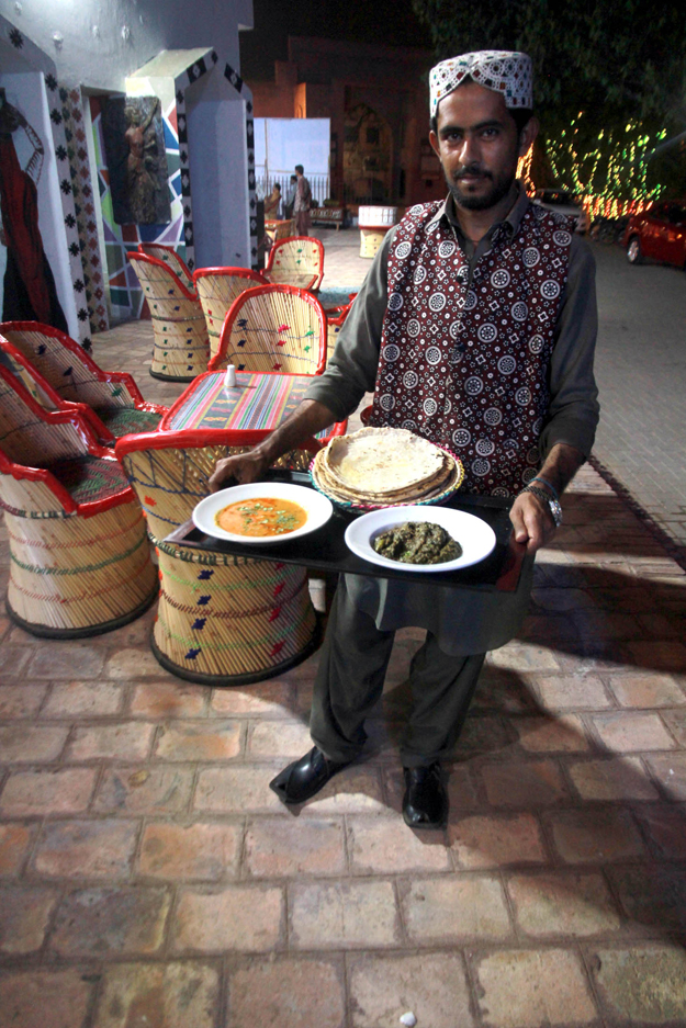 The seating arrangement and folk music being played at the cafÃ© showcase Sindhi culture, as does the attire of the waiters who wear Sindhi topis and ajrak waistcoats. PHOTO: ATHAR KHAN