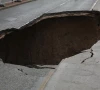 three motorbikes fall into sinkhole
