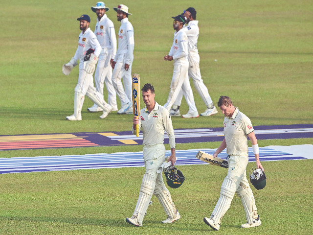 australia s alex carey c acknowledges the crowd as he and captain steve smith r walk back to the pavilion at the end of the second day of the second test against sri lanka at galle photo afp