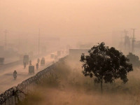 an aerial shot shows people commute along a street amid heavy smoggy conditions in lahore photo afp file