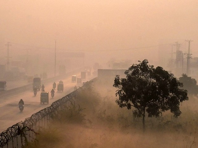 an aerial shot shows people commute along a street amid heavy smoggy conditions in lahore on thursday photo afp
