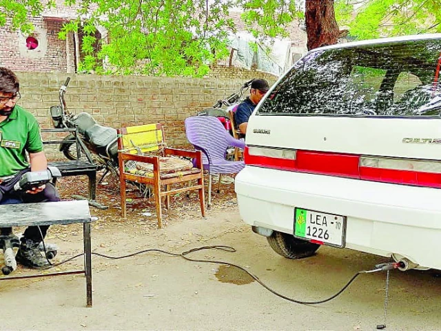 an official of the punjab environmental protection agency epa conducts smoke emission test of a car in lahore as part of measures to prevent smog testing fees of rs100 for motorbikes rs300 for rickshaws and rs500 to rs2 000 for cars have been levied photo rizwan anwar express
