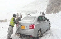 workers push a stranded car along a snow covered road in abbottabad after the region received its first snowfall of the season photo ppi workers push a stranded car along a snow covered road in abbottabad after the region received its first snowfall of the season photo ppi