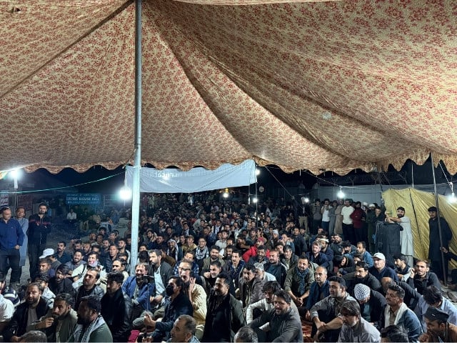 Residents sitting at KKH near customs terminal Afiyatabad Sost, Gilgit. Sept 21, 2025. Saleem Rumi