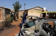 emergency personnel cordon off an area next to burnt vehicles at the site of a deadly shooting at a tavern in wedela township southwest of johannesburg south africa september 27 2026 photo reuters