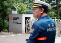 a police officer controls the area in front of the main gate of hanwha aerospace s factory that caught fire after an explosion in daejeon south korea on june 1 2026 photo reuters