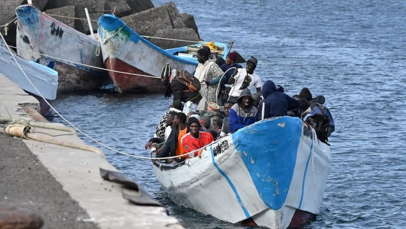 migrants sit in a boat after the spanish salvamento maritimo sea search and rescue agency rescued around 250 migrants in three different boats at sea at la restinga port in the municipality of el pinar on the canary island of el hierro on february 4 2023 photo afp