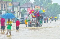 people move through a flooded road on the outskirts of colombo photo afp