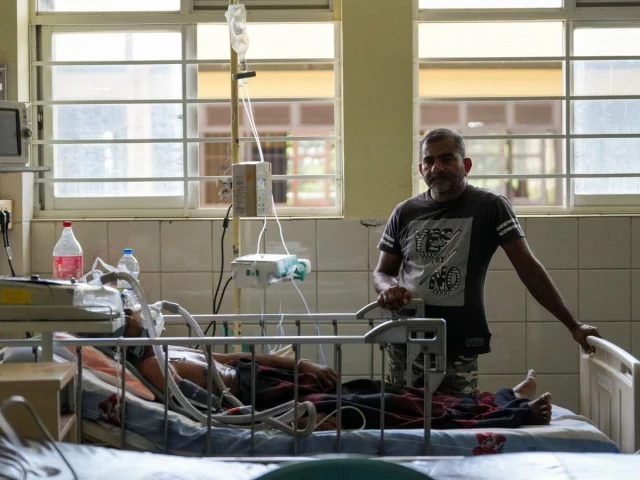 a dengue patient lies on the hospital bed while his son stands next to him at district general hospital in negombo sri lanka july 16 2026 photo reuters a dengue patient lies on the hospital bed while his son stands next to him at district general hospital in negombo sri lanka july 16 2026 photo reuters