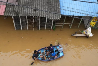 people ride in a boat at a flooded area following heavy rainfall in malwana sri lanka november 29 2025 photo reuters
