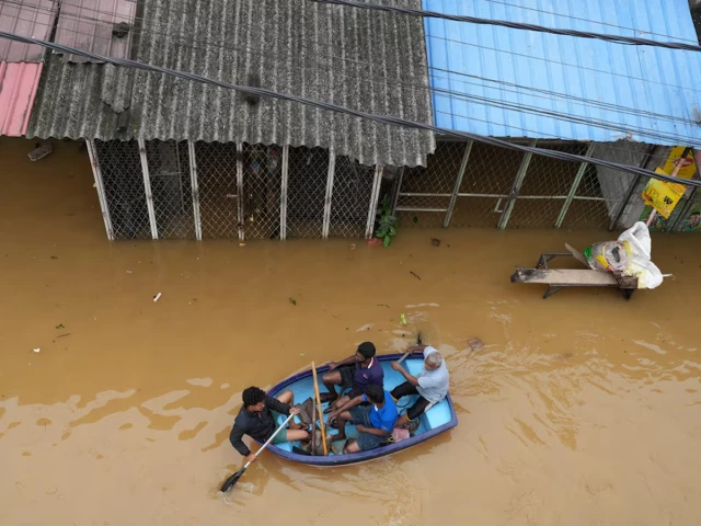 people ride in a boat at a flooded area following heavy rainfall in malwana sri lanka november 29 2025 photo reuters people ride in a boat at a flooded area following heavy rainfall in malwana sri lanka november 29 2025 photo reuters