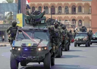 a member of the iraqi security forces flashes the victory sign during a military parade marking the withdrawal of the us led coalition from iraq in baghdad photo afp