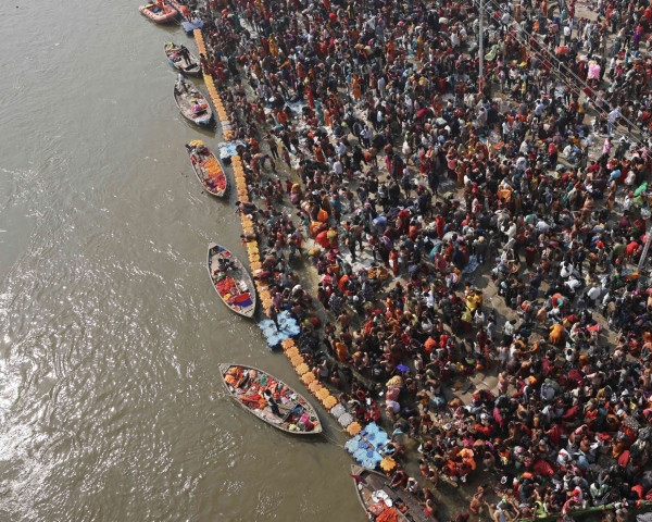 Hours after the crowd crush, devotees gather at the banks of the Sangam. Photo: AFP